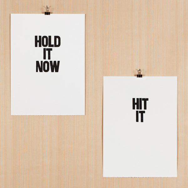 Letterpress poster pair with the sayings "Hold it now" and "Hit it"