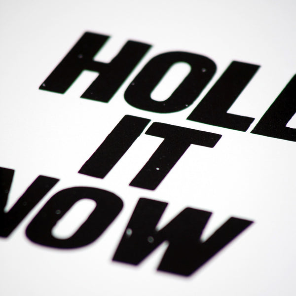 Letterpress poster with the saying "Hold it now"